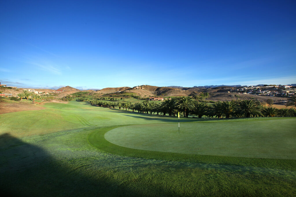 Hole with trees and hills in background at Salobre Golf - Old Course