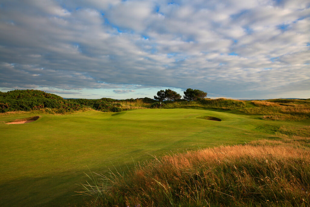 Hole with bunkers at The Castle Course at St Andrews with trees around