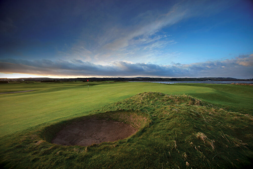 Hole with red flag and bunker at The Old Course at St Andrews