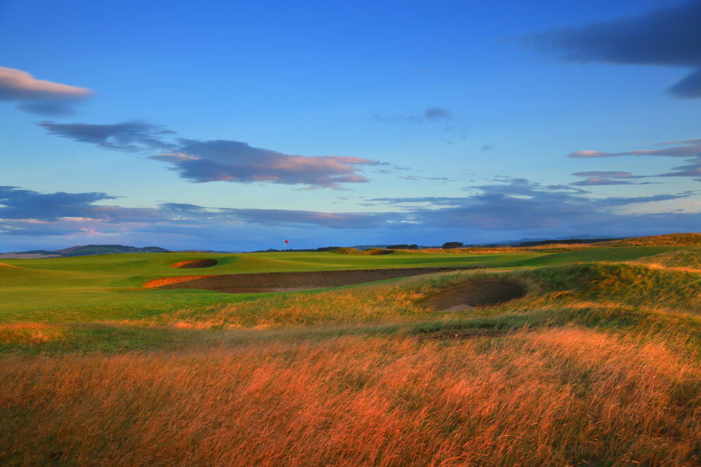 Hole with red flag and bunkers at The Old Course at St Andrews