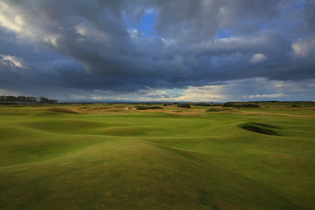 Hole with white flag at The Old Course at St Andrews with bunkers