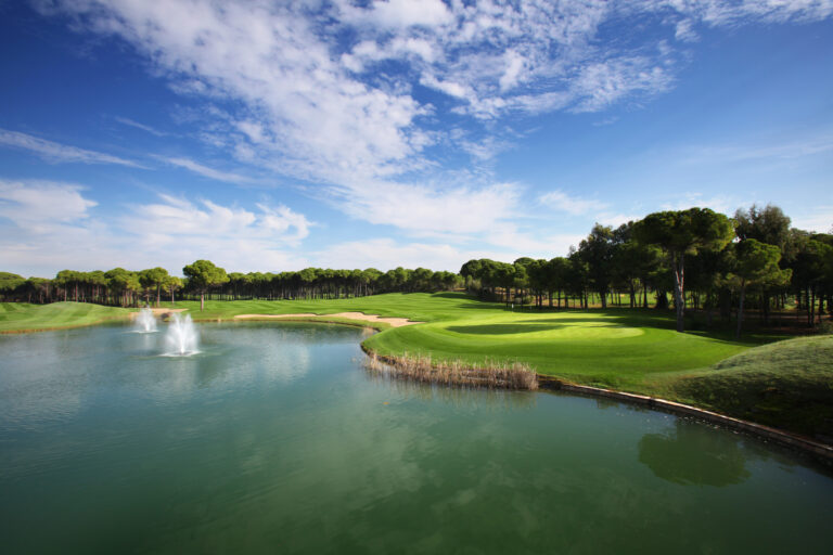 Lake with fairway and trees around at Sueno Golf Club - Dunes Course