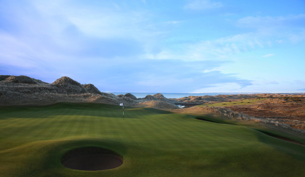 Hole with bunker at Trump International Golf Links with mounds around