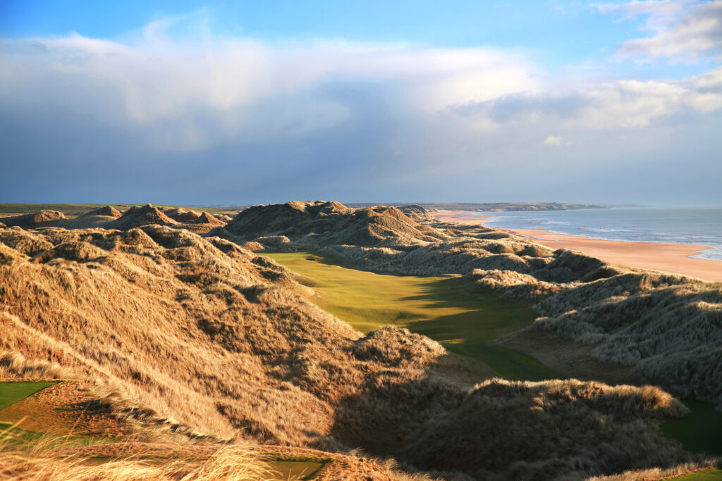 Aerial view of fairway with mounds either side at Trump International Golf Links with beach