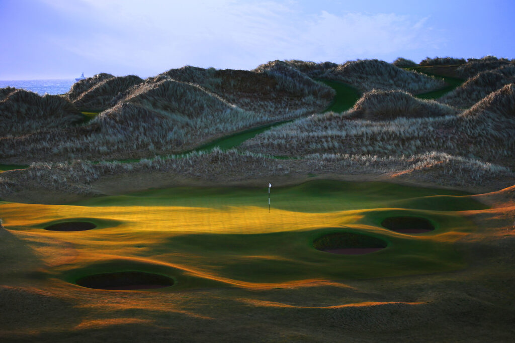 Hole with bunkers at Trump International Golf Links with mounds around