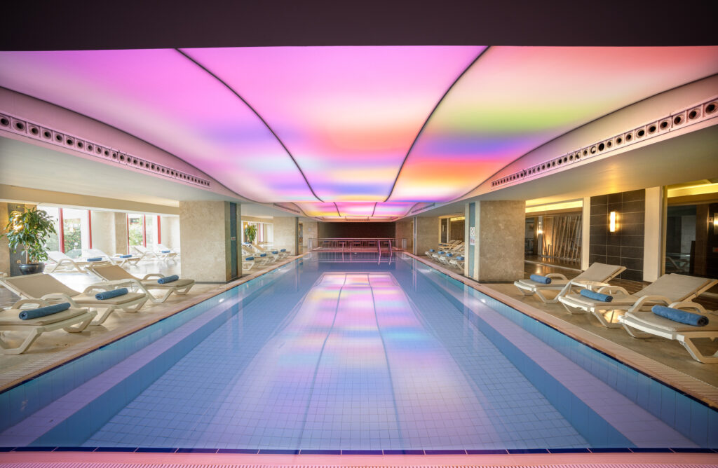 Indoor pool with sunset coloured led lighting at Kaya Belek Hotel