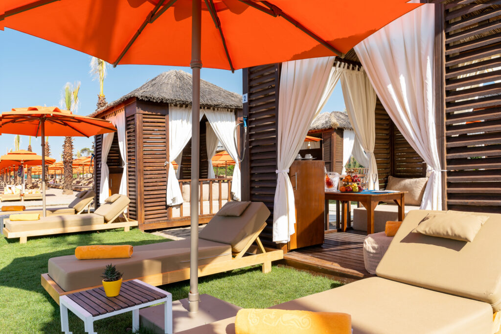 Loungers with red umbrellas at Kaya Palazzo Golf Resort