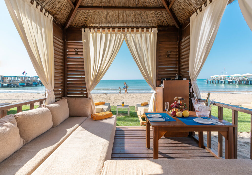 Sofa in hut on beach at Kaya Palazzo Golf Resort