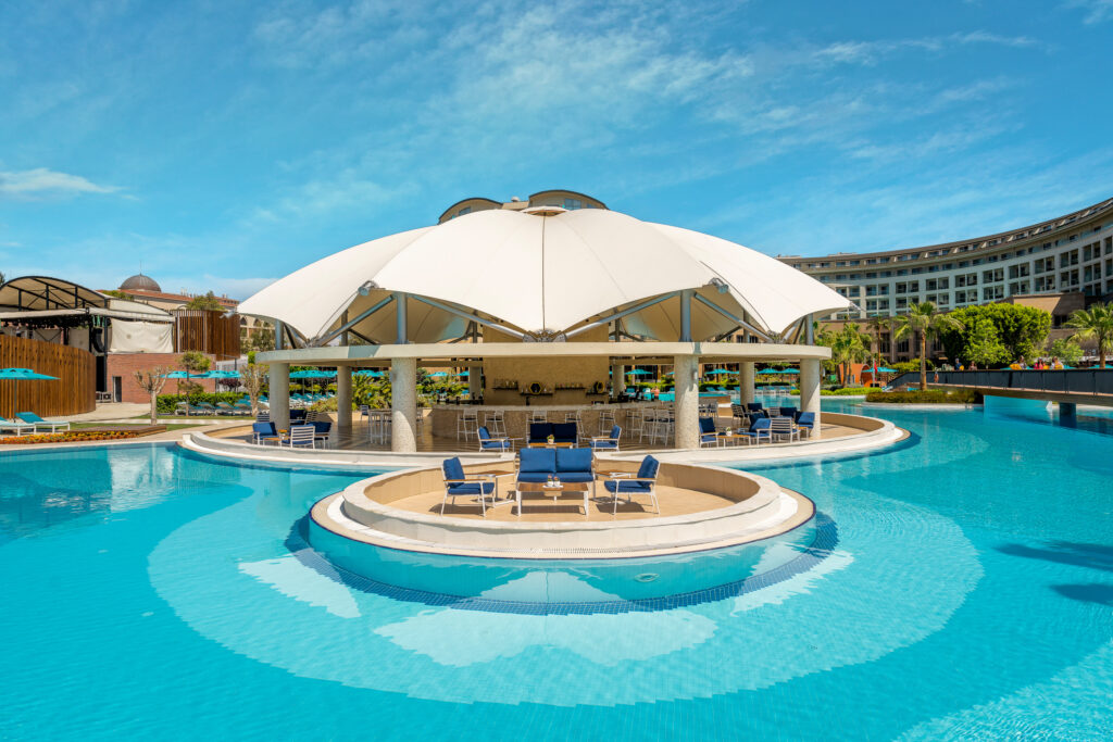 Outdoor pool with outdoor bar at Kaya Palazzo Golf Resort