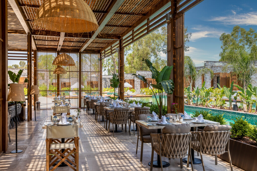 Outdoor dining at Kaya Palazzo Golf Resort with view of outdoor pool