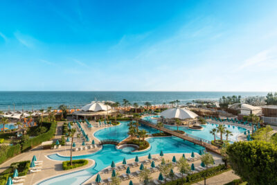 Outdoor pool at Kaya Palazzo Golf Resort with ocean view