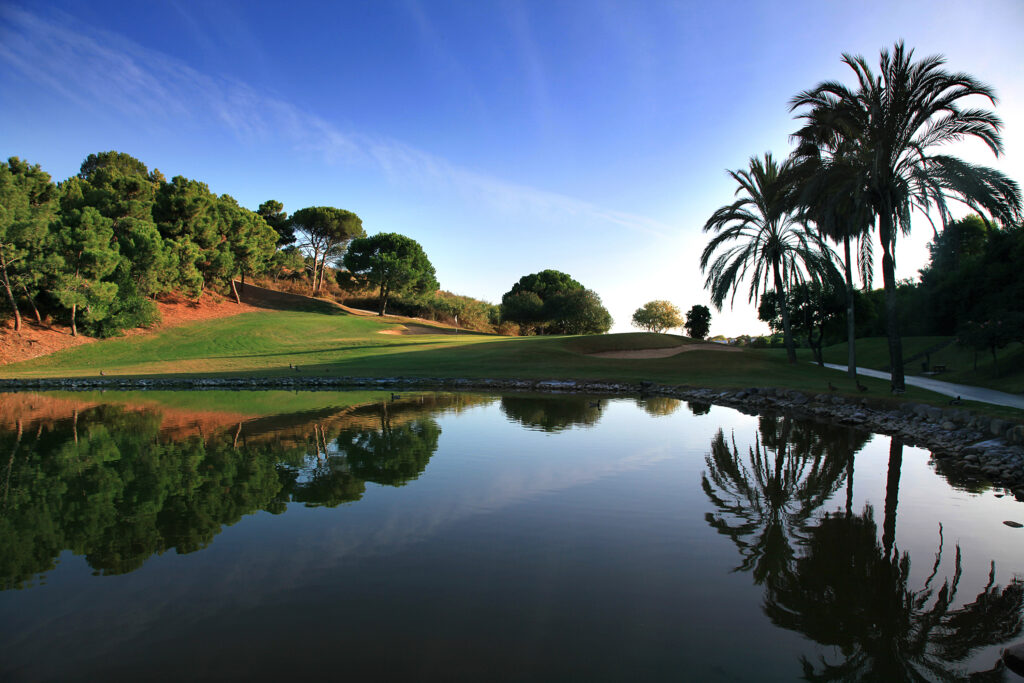 Fairway with lake and trees with hole in background at La Quinta Golf Course