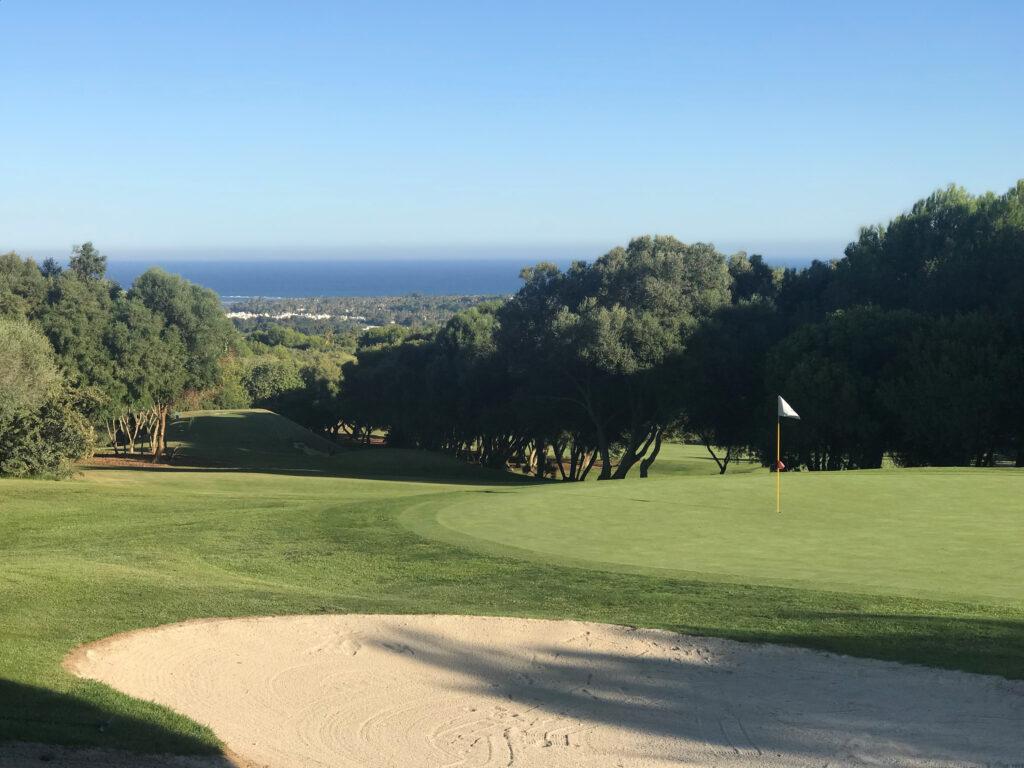 Hole with bunker at La Canada Golf Course with trees around