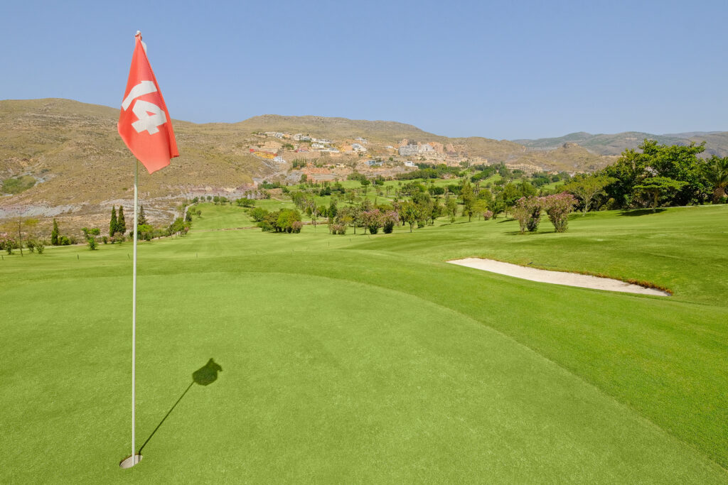 Hole with red flag and bunker at La Envia Golf Course