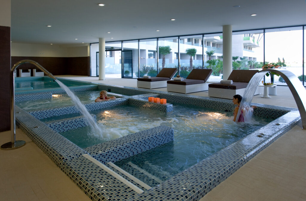 Indoor pool with water fountains at La Finca Resort