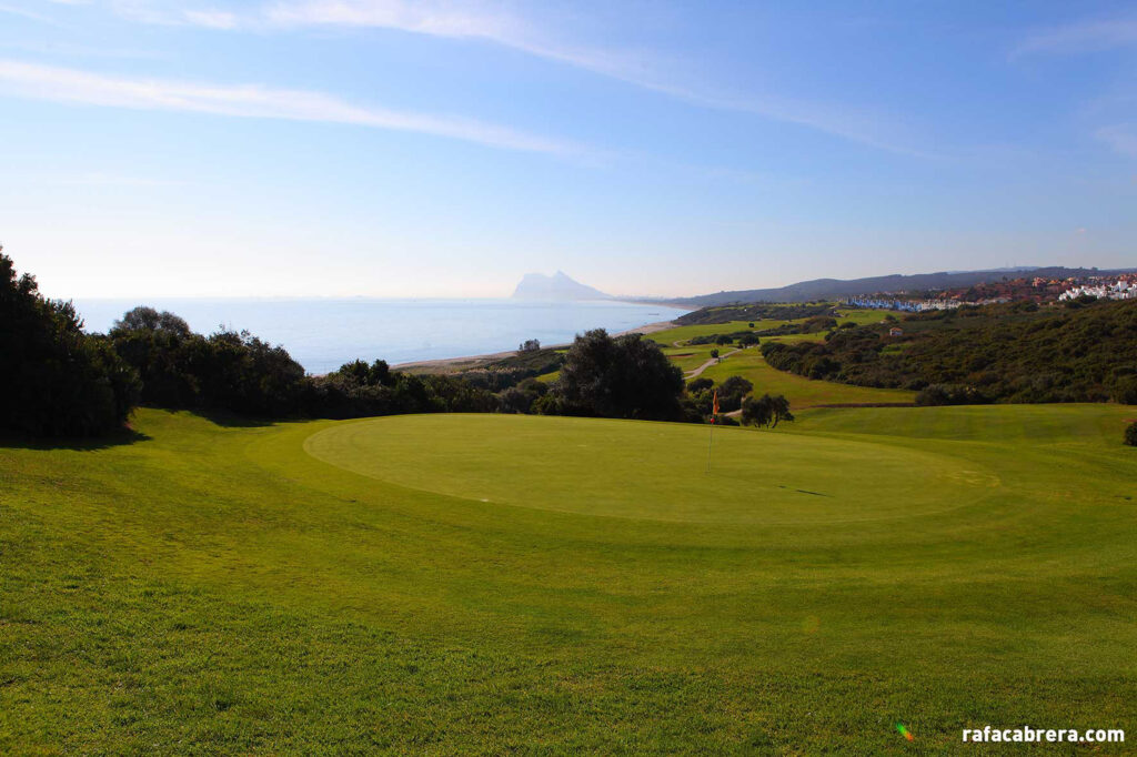 Hole with red flag and beach in distance at La Hacienda Alcaidesa Links Golf Resort - Links Course