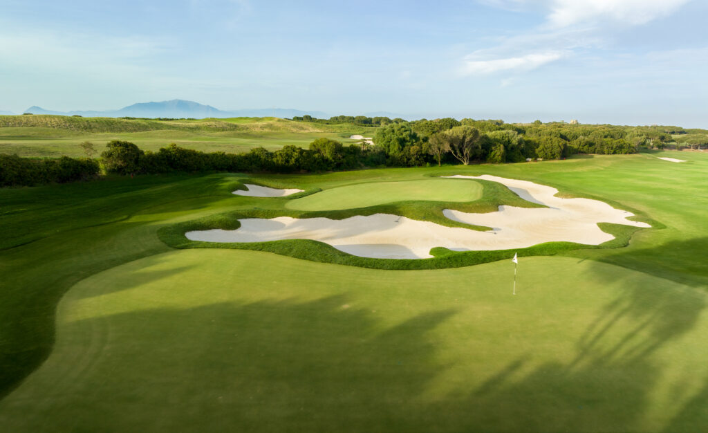 Hole with bunkers and trees in background at La Hacienda Alcaidesa Links Golf Resort - Links Course