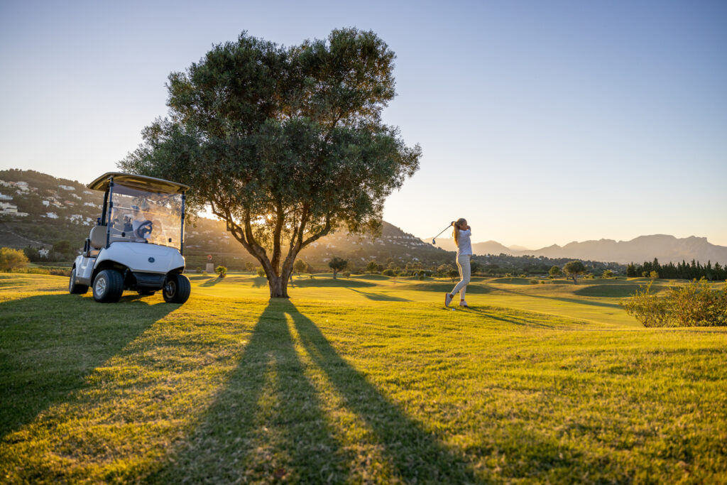 People playing golf at La Sella Golf Course with buggy