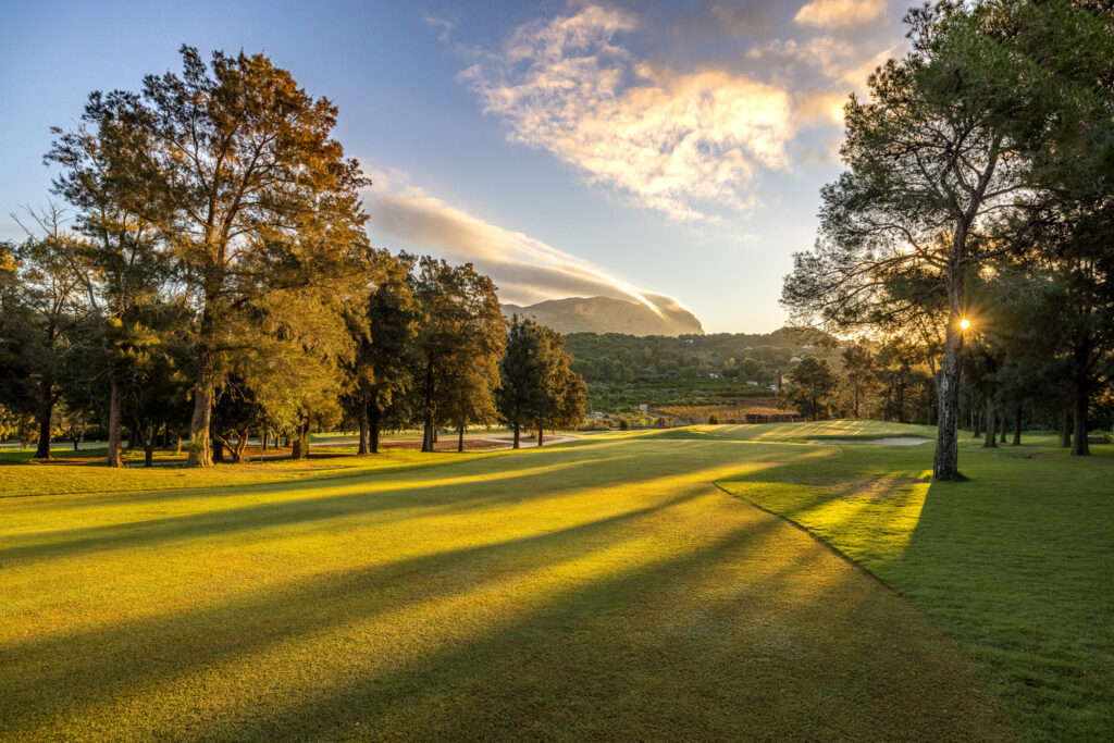 Fairway with trees around and sun shining through at La Sella Golf Course