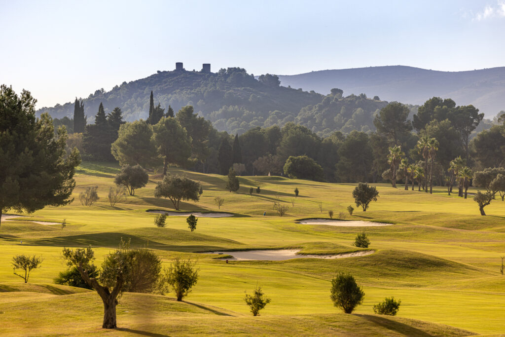 Fairway with bunkers and trees around at La Sella Golf Course