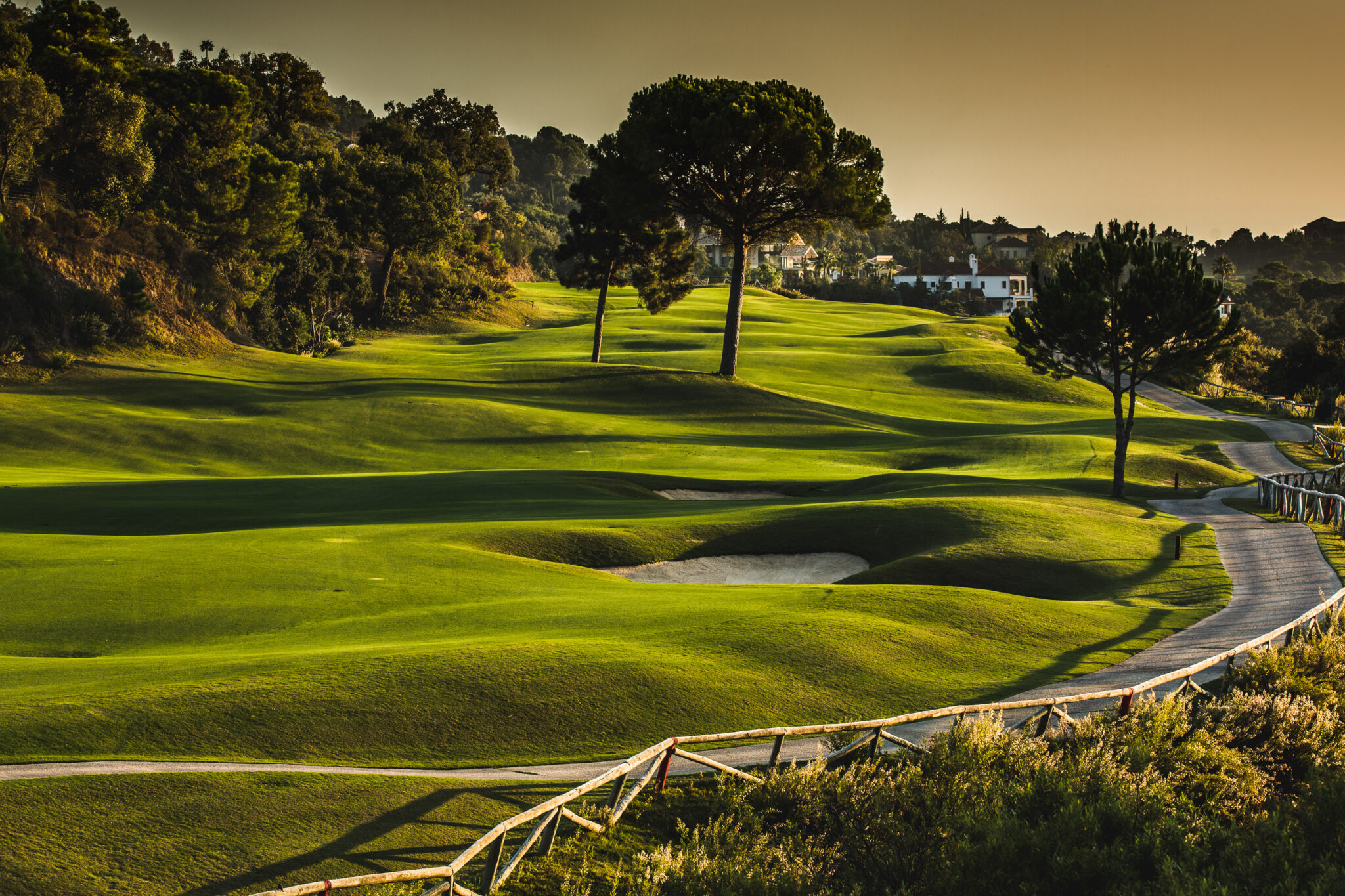 Bunkers and trees on fairway at sunset at La Zagaleta - New Golf Course