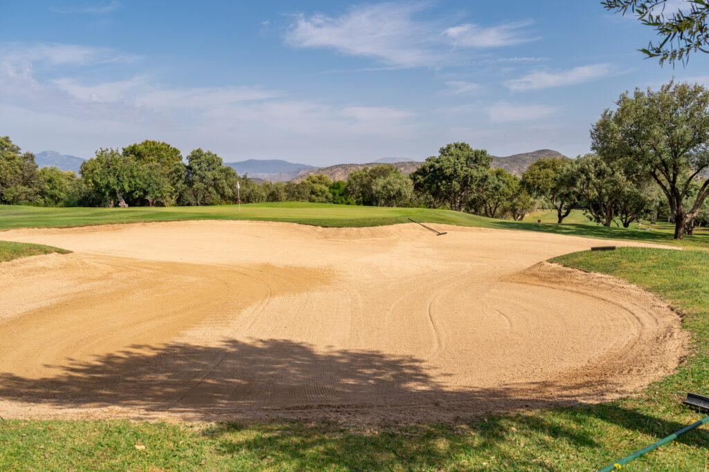 Bunker on fairway with trees around at Lauro Golf Course