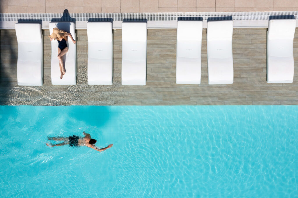 People swimming in the outdoor pool at Leonardo Plaza Cypria Maris