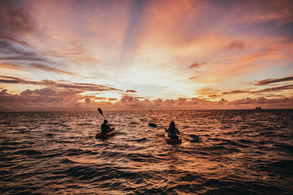 People kayaking in ocean at Long Beach (Sunlife Resort) at sunset