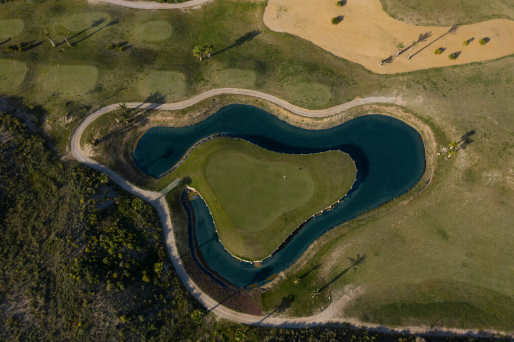 Aerial view of hole with lake around it at Lorca Golf Course