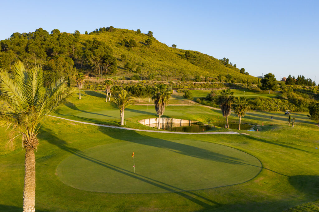 Hole with hill and trees around at Lorca Golf Course