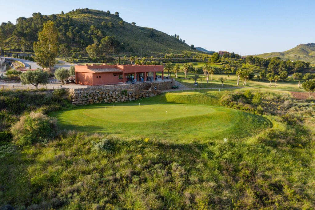 Practice facilities with building and hill in background at Lorca Golf Course