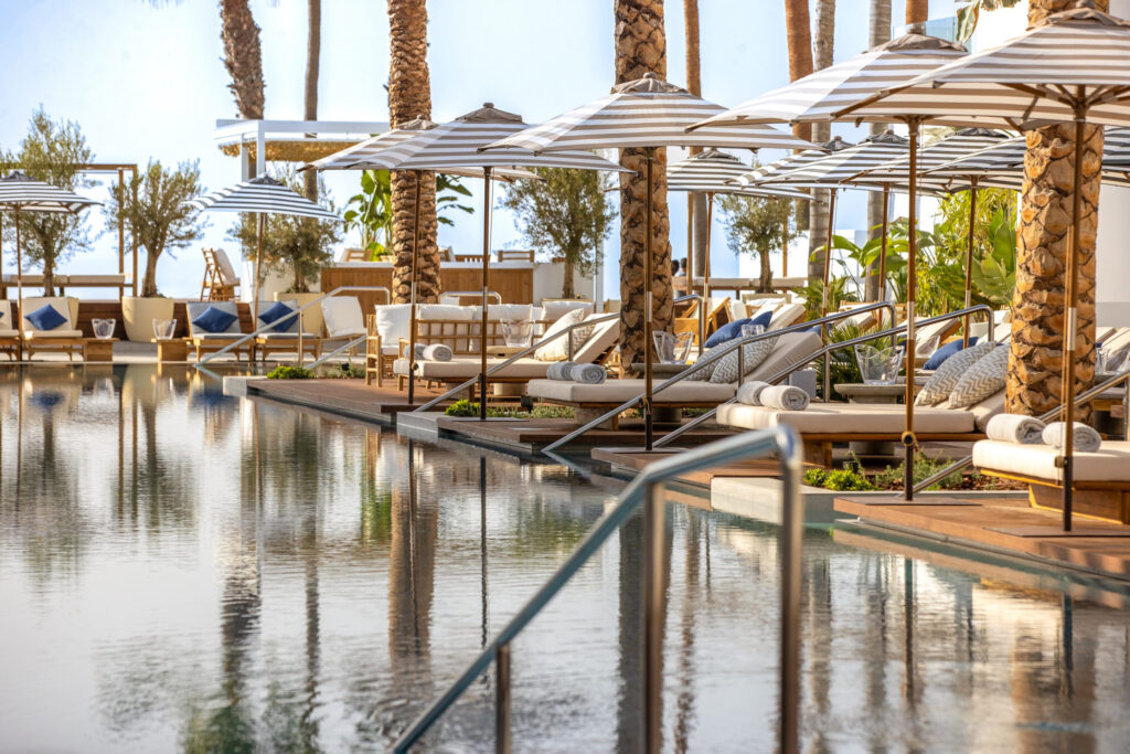 Outdoor pool with loungers at METT Hotel Beach Resort