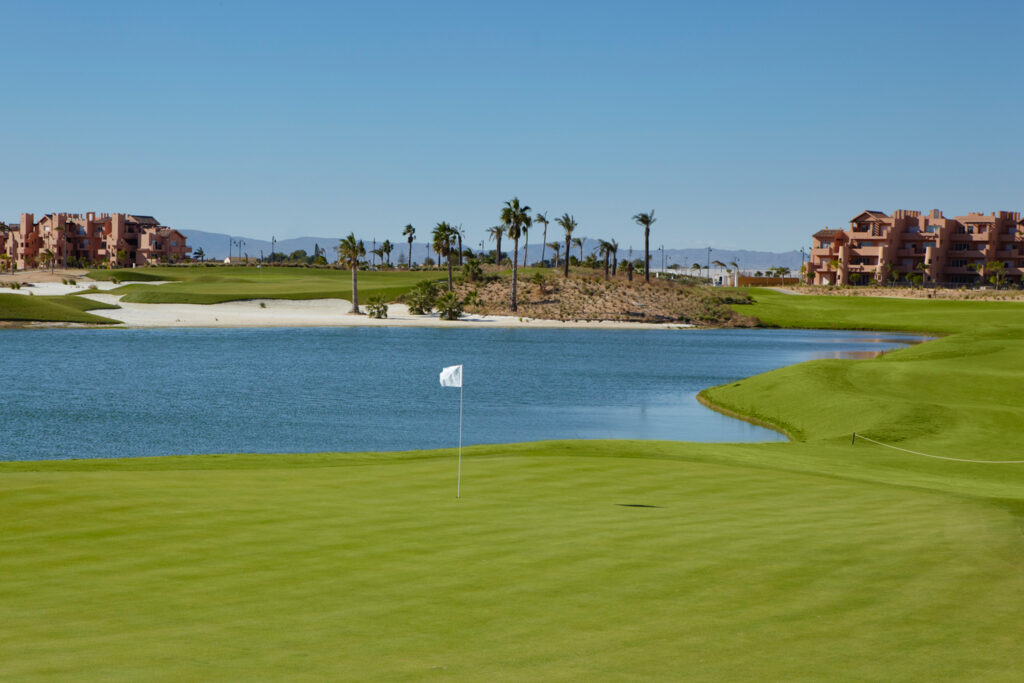 A hole with a lake in background at Mar Menor Golf Course