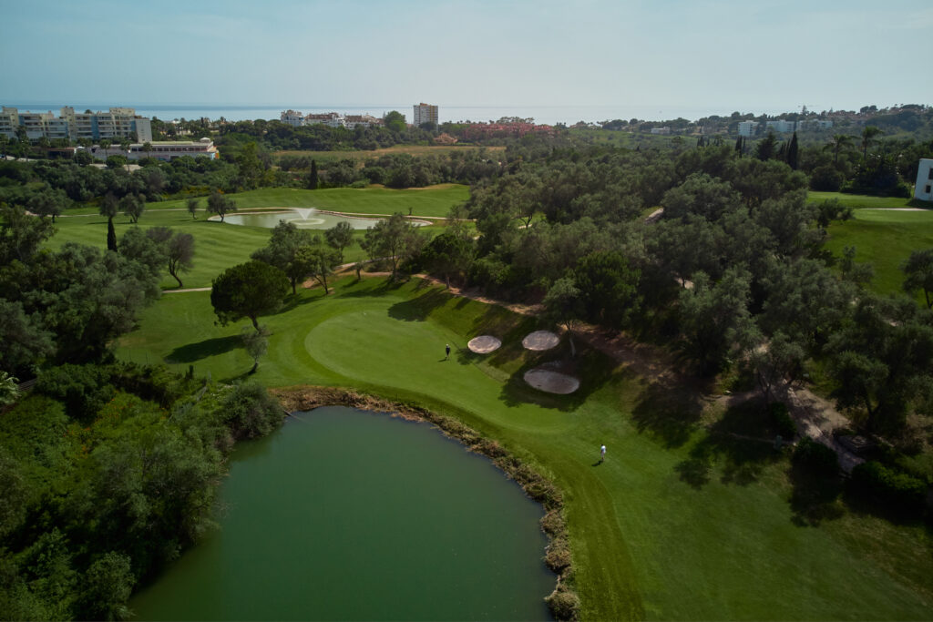 Lake next to a hole at Marbella Golf & Country Club with trees around