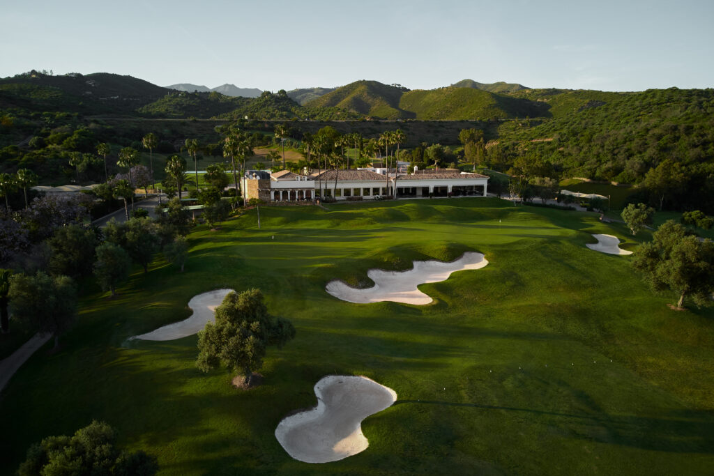 Bunkers on fairway with country club in background at Marbella Golf & Country Club