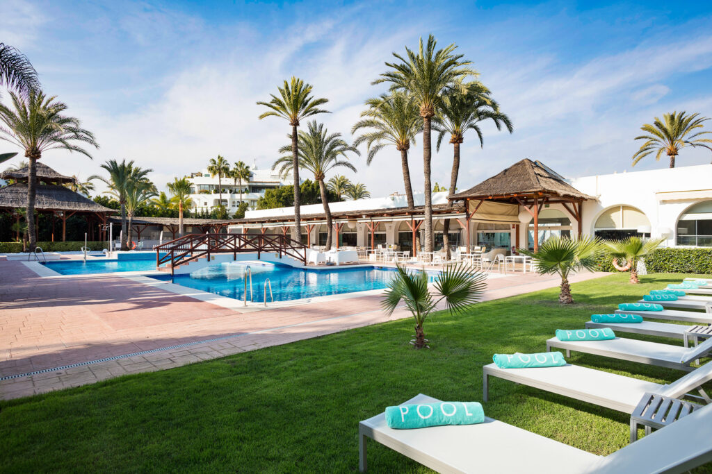 Outdoor pool with loungers at Melia Marbella Banus