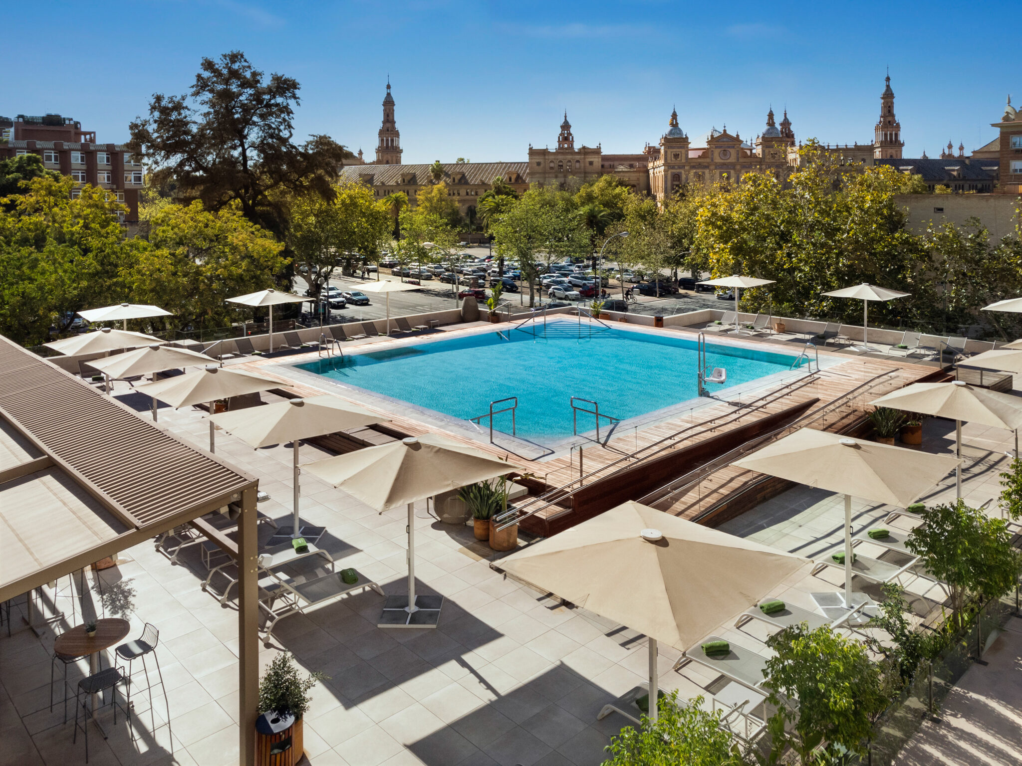 Outdoor pool with sun loungers at Melia Sevilla