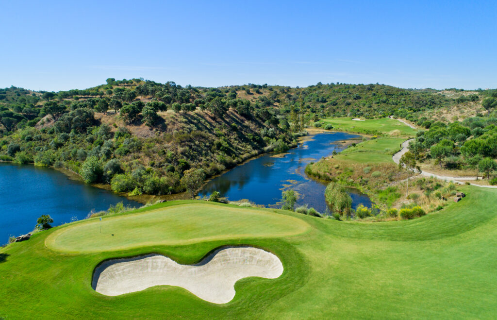 Aerial view of a hole at Monte Rei golf course with lake in background