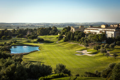 Aerial view of the fairway with lake and hotel in background at Montecastillo Golf Course