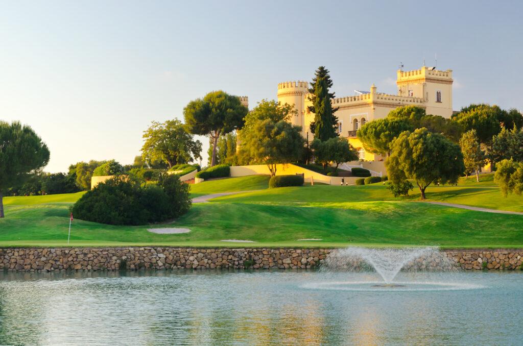 Lake with fountain with fairway and building in background at Montecastillo Golf Course