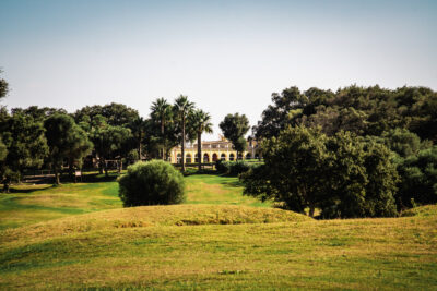 Fairway with trees on and building in the background at Montenmedio Golf & Country Club