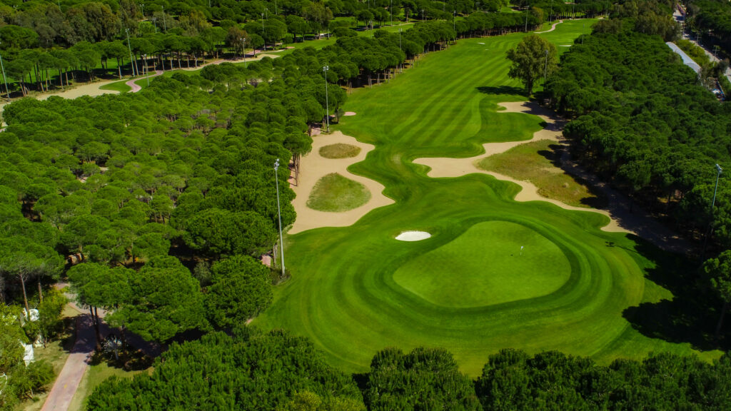 Aerial view of bunkers on fairway with trees around at Montgomerie Maxx Royal Golf Course