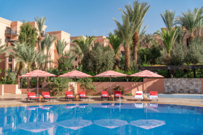 Outdoor pool with loungers at Movenpick Hotel Mansour Eddahbi Marrakech