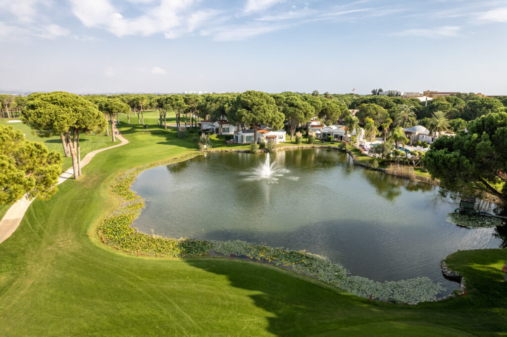 Lake with fountain at Nobilis Golf Course with trees around