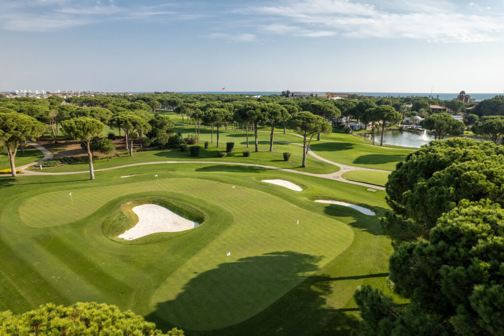 Aerial view of Nobilis Golf Course with bunkers and trees around