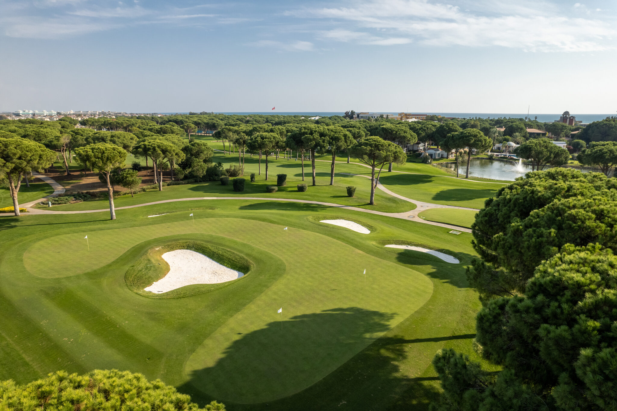 Aerial view of Nobilis Golf Course with bunkers and trees around