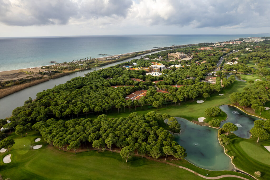 Aerial view of Nobilis Golf Course with trees and ocean view