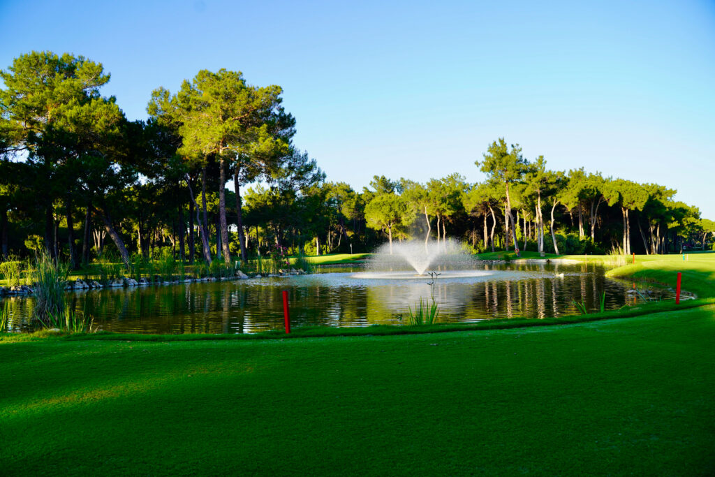 Lake with fountain with trees in background at Nobilis Golf Course