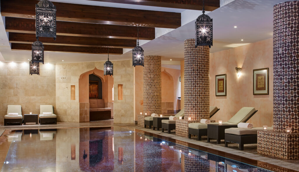 Indoor pool with loungers at ONA Mar Menor Golf & Spa