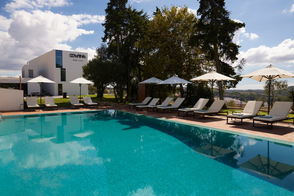 Outdoor pool with sun loungers at Octant Santiago Hotel